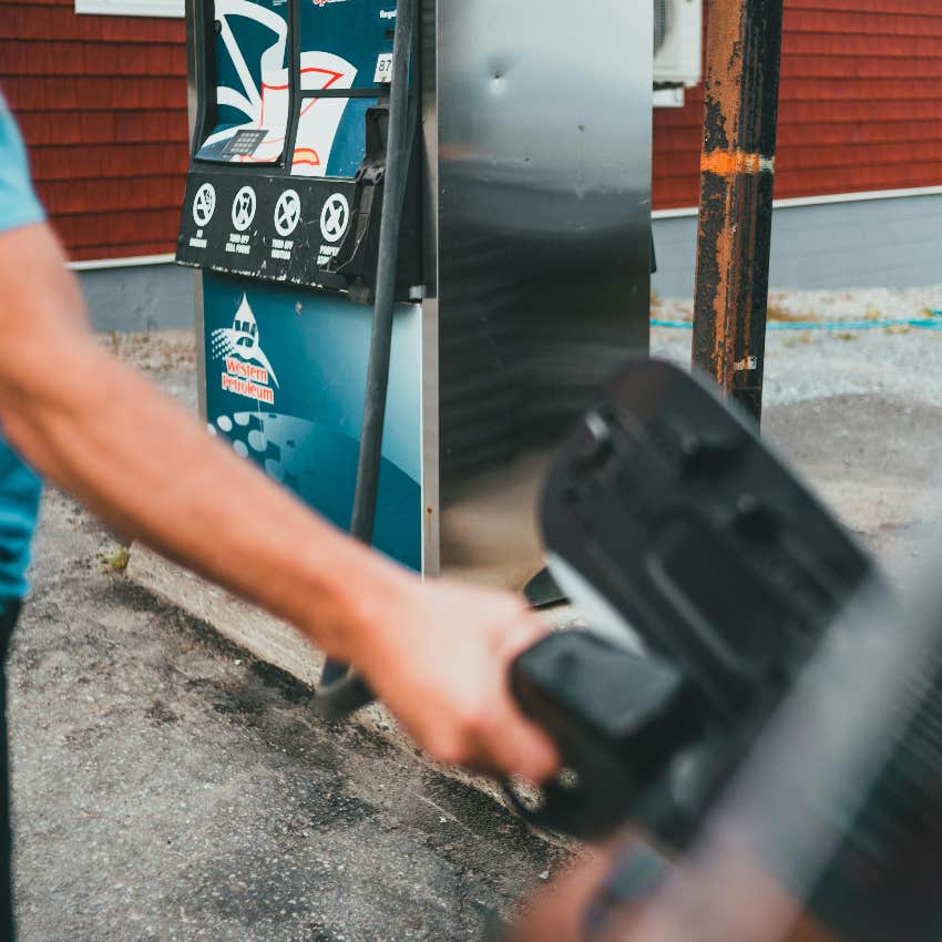 person filling their car with leaded gasoline