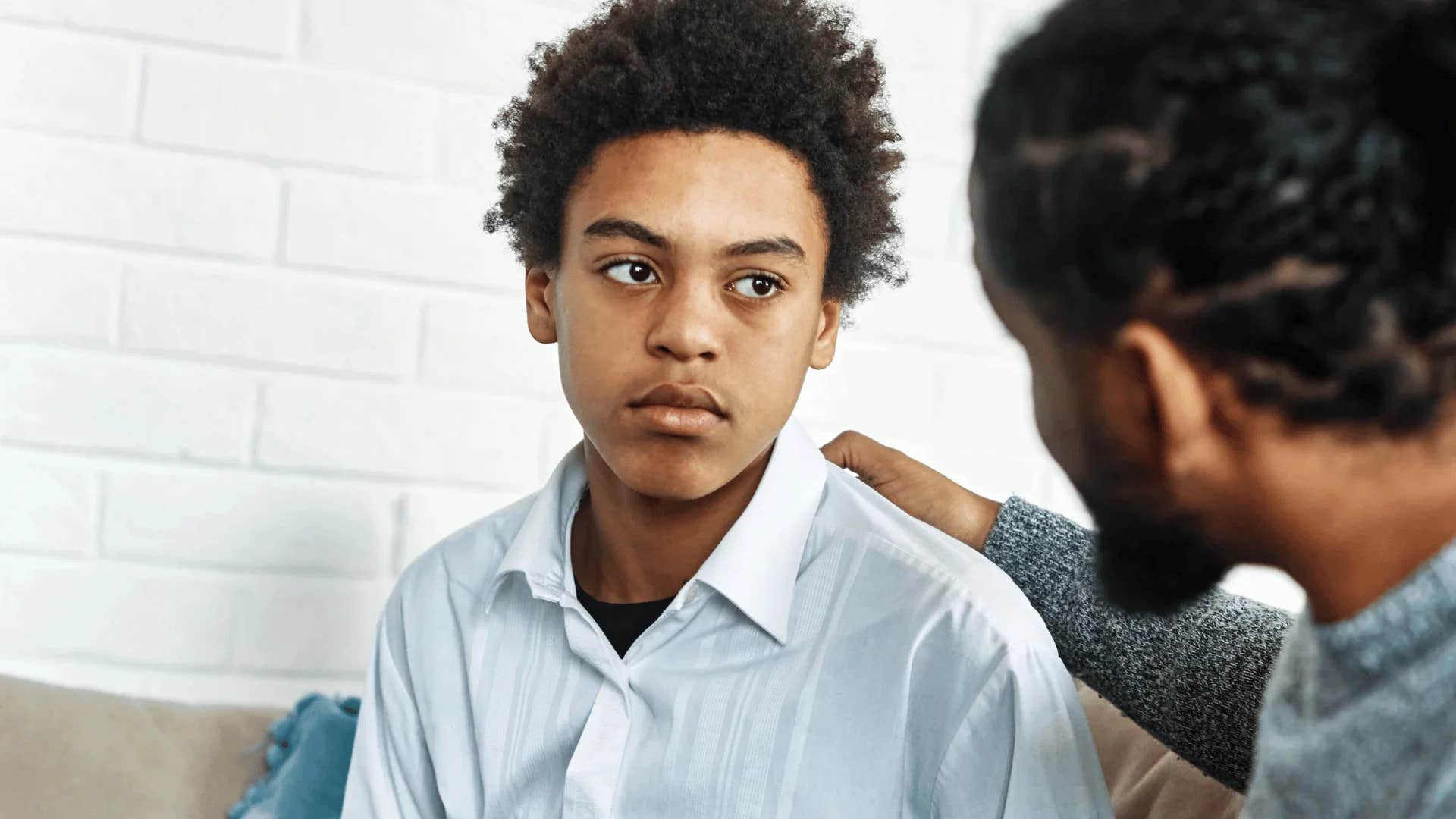 father offering advice to young son but not encouraging him