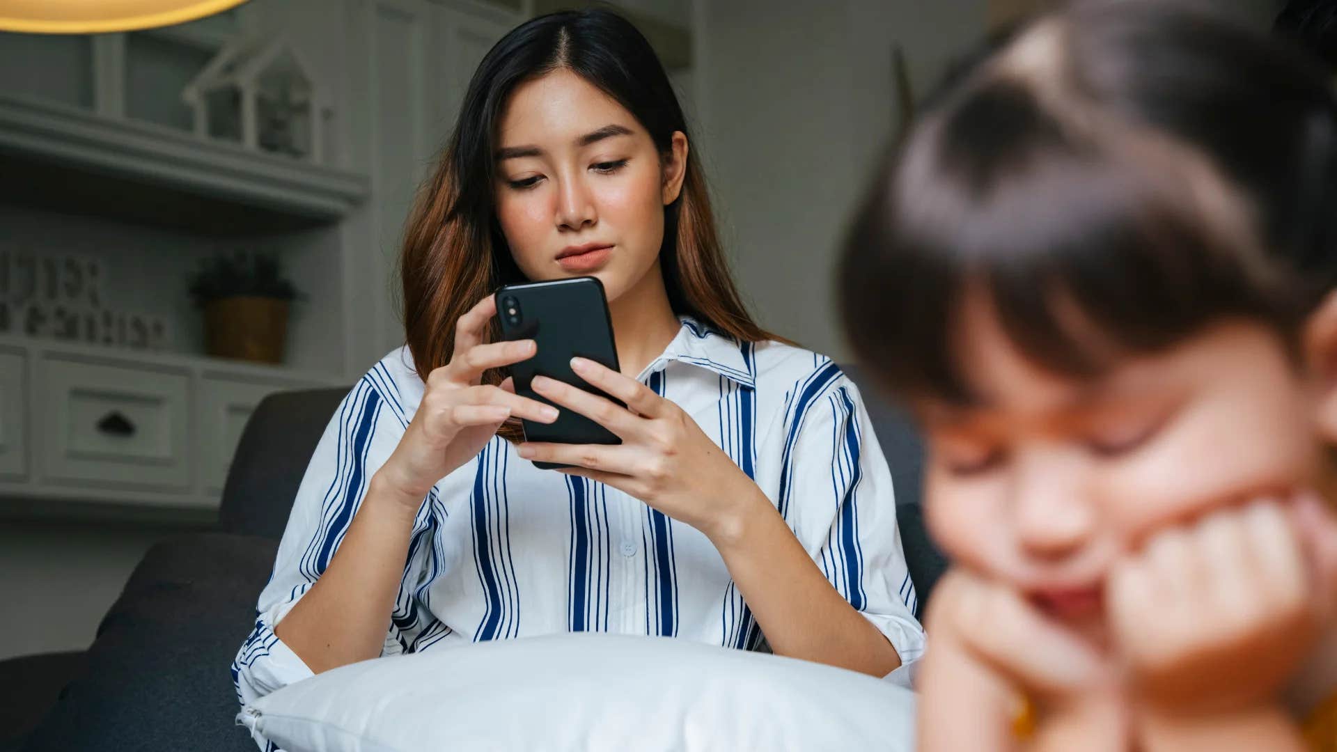 distracted mom ignoring young daughter who wants to ask question
