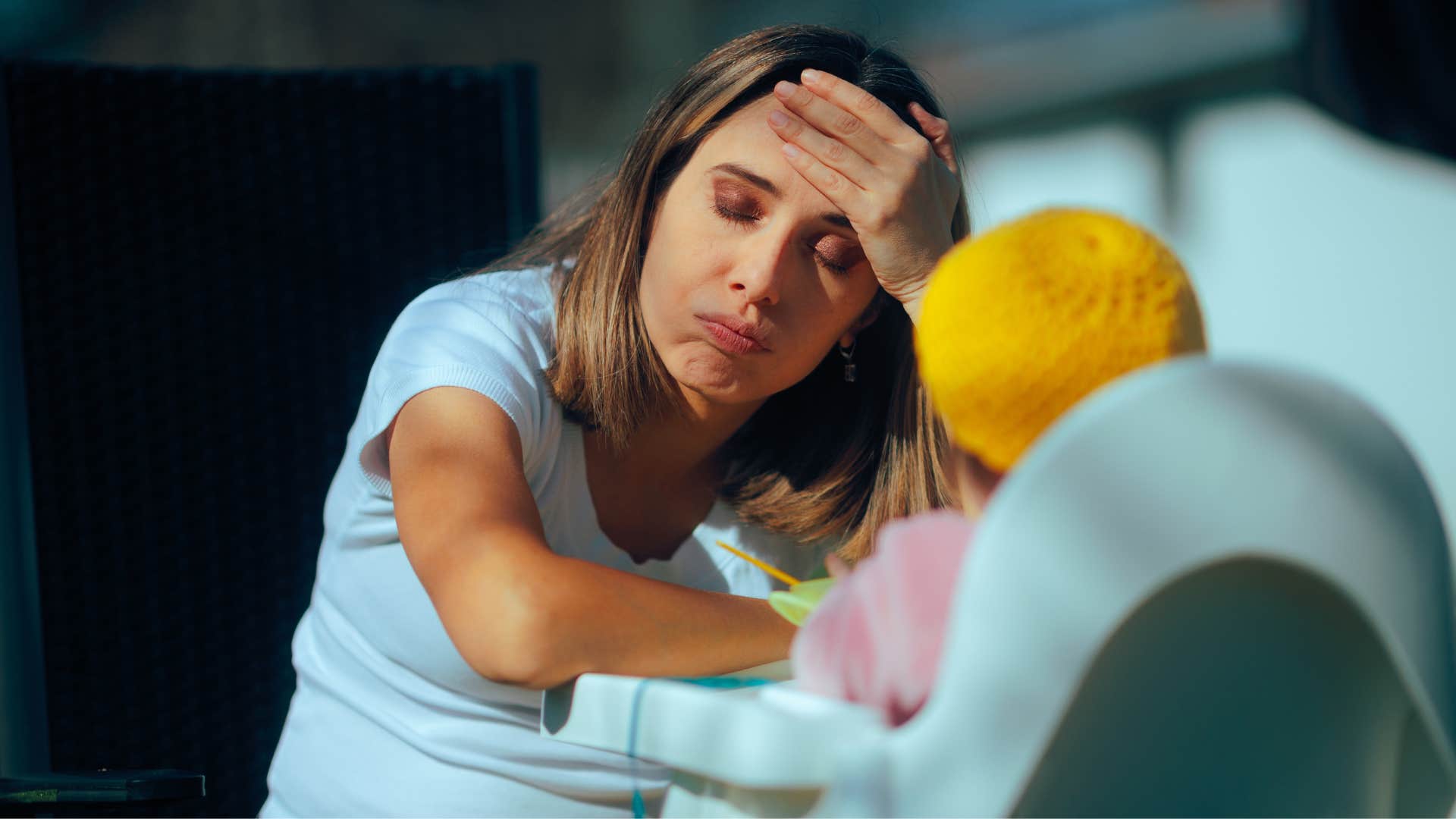 stressed low-quality parent feeding child while thinking she never wanted kids