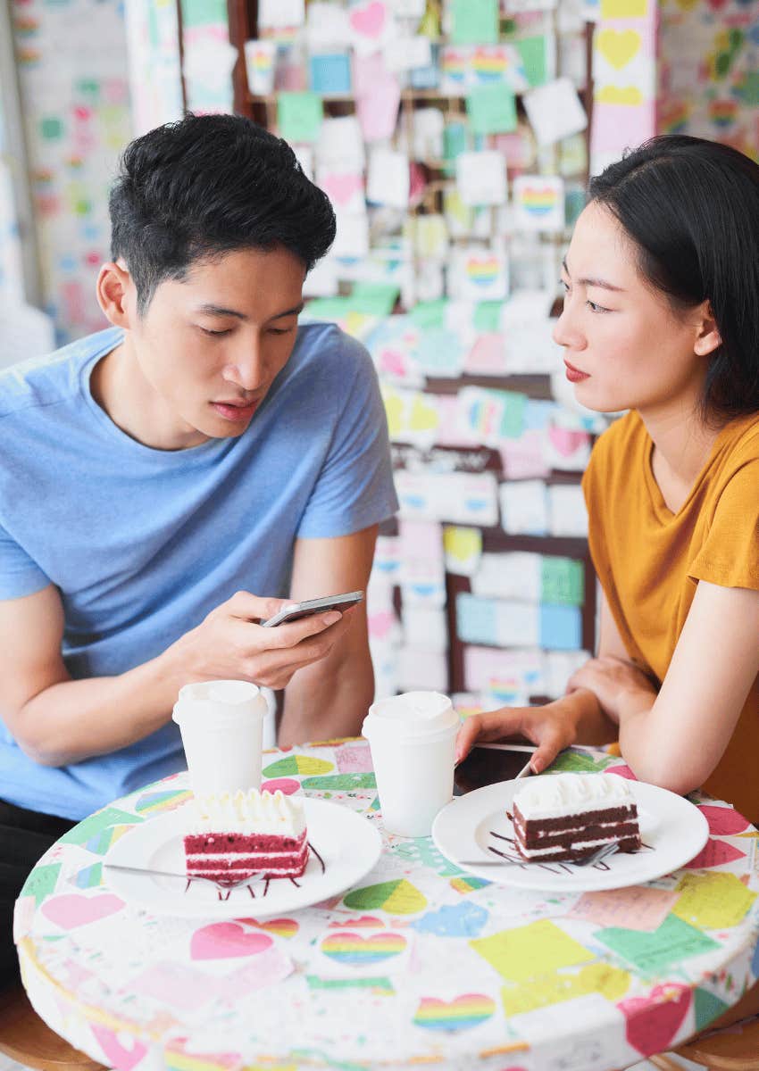 man responding to texts while on date