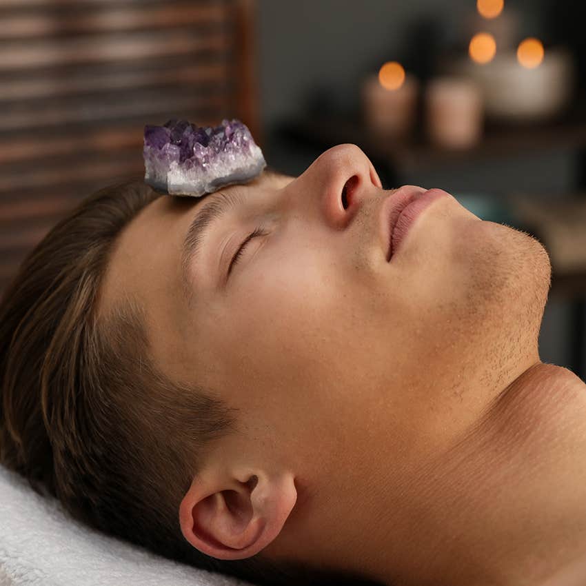 man meditating with amethyst on forehead