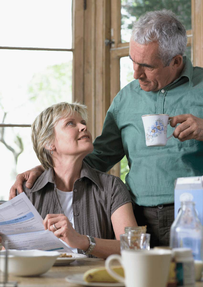mature man with his hand on mature woman's shoulder