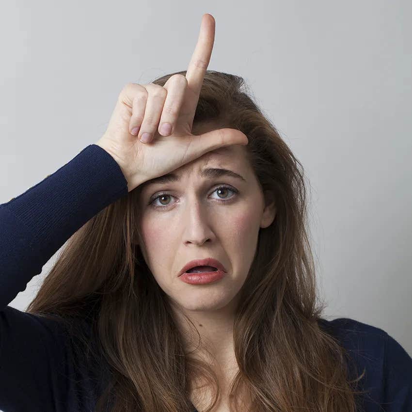 millennial woman doing the loser hand gesture would make gen alpha crash out