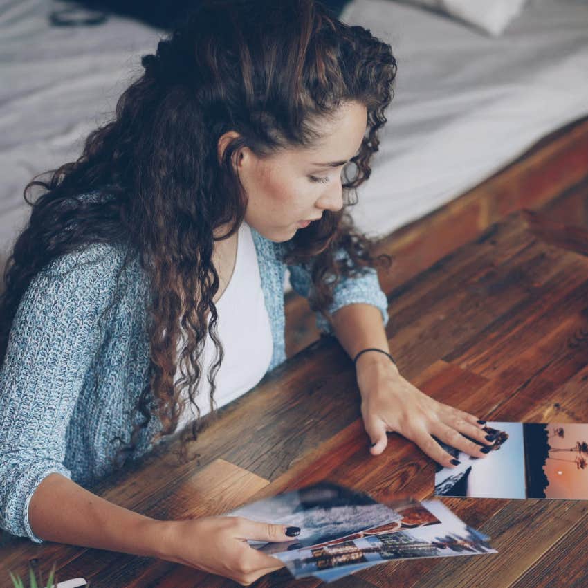 millennial woman looking through pictures from high school