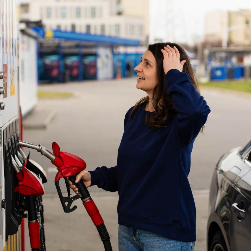 woman shocked over the price of gas trying to fill up car
