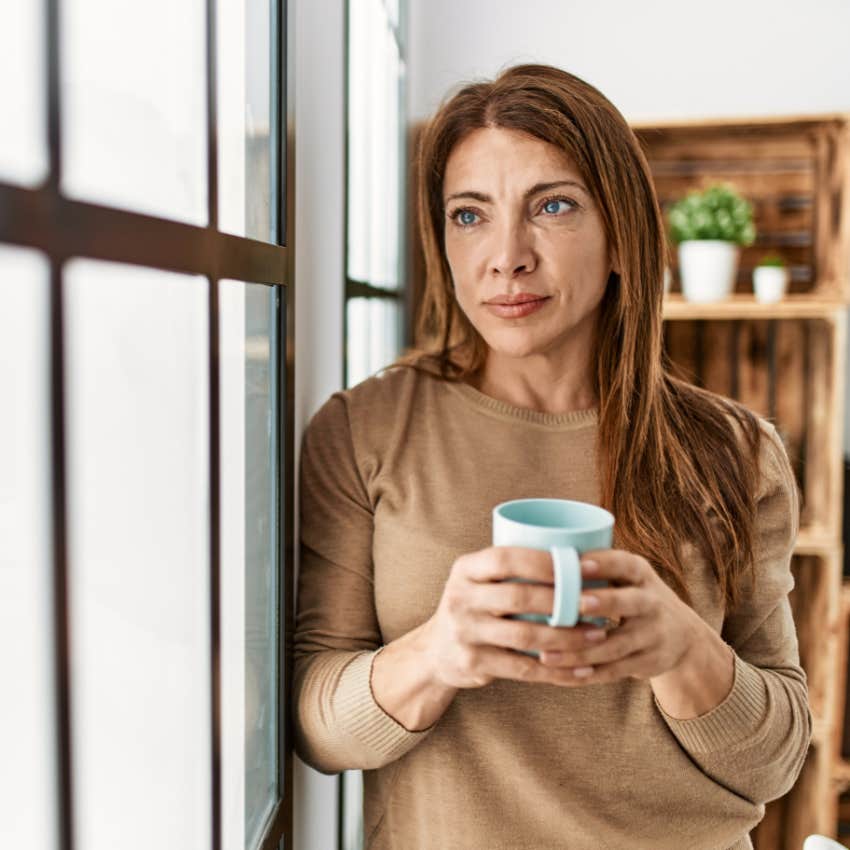smiling woman with a strong sense of identity drinking coffee
