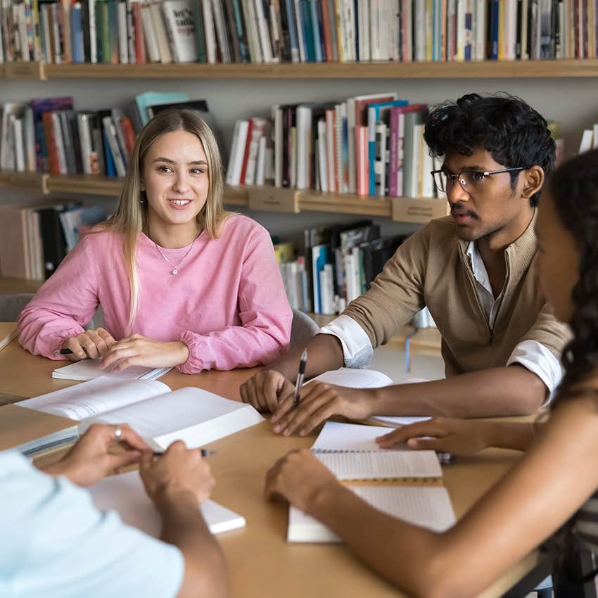 four students participating in group activity