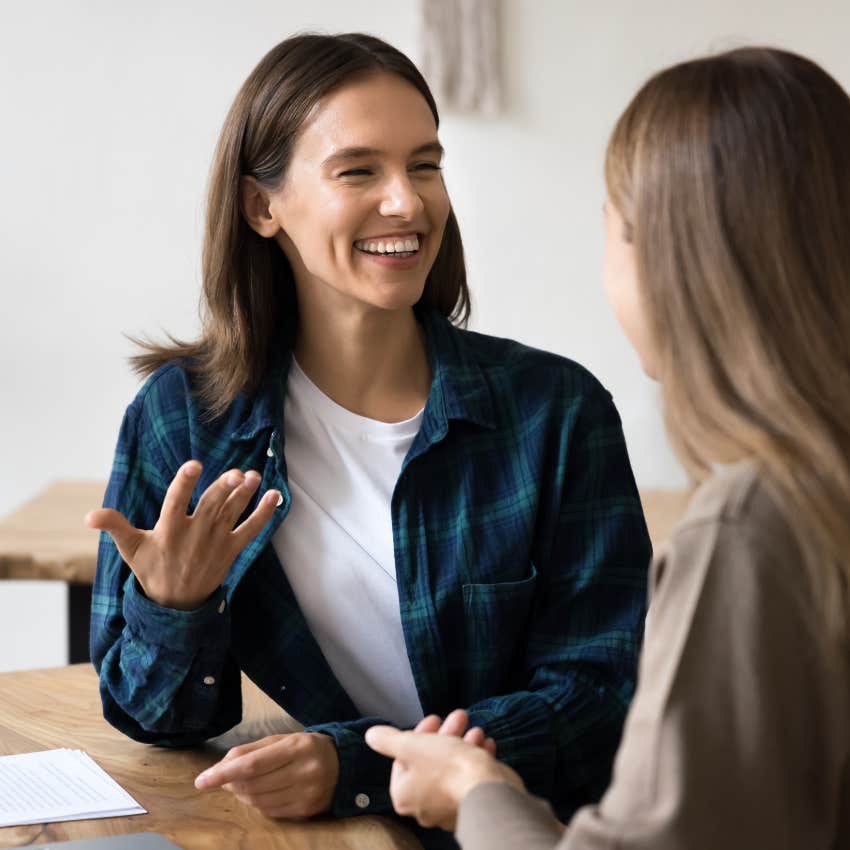 two women smiling having conversation