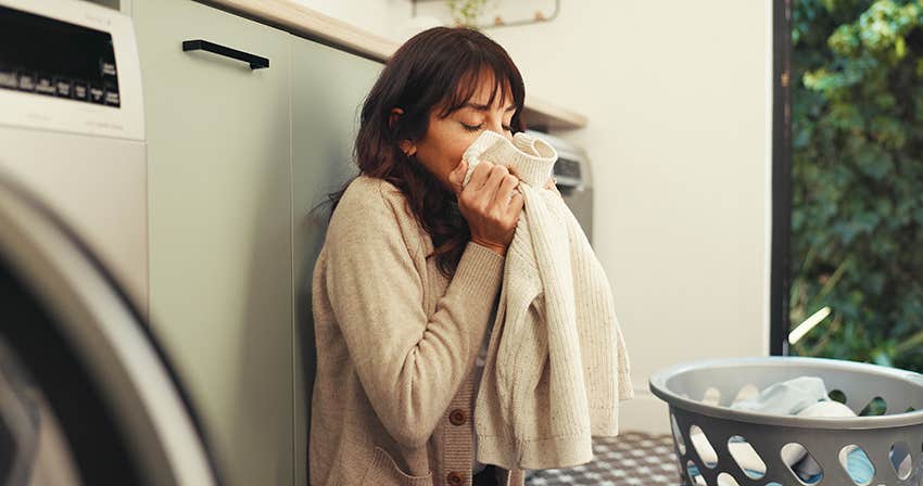 woman smelling fresh cotton laundry to calm her anxiety
