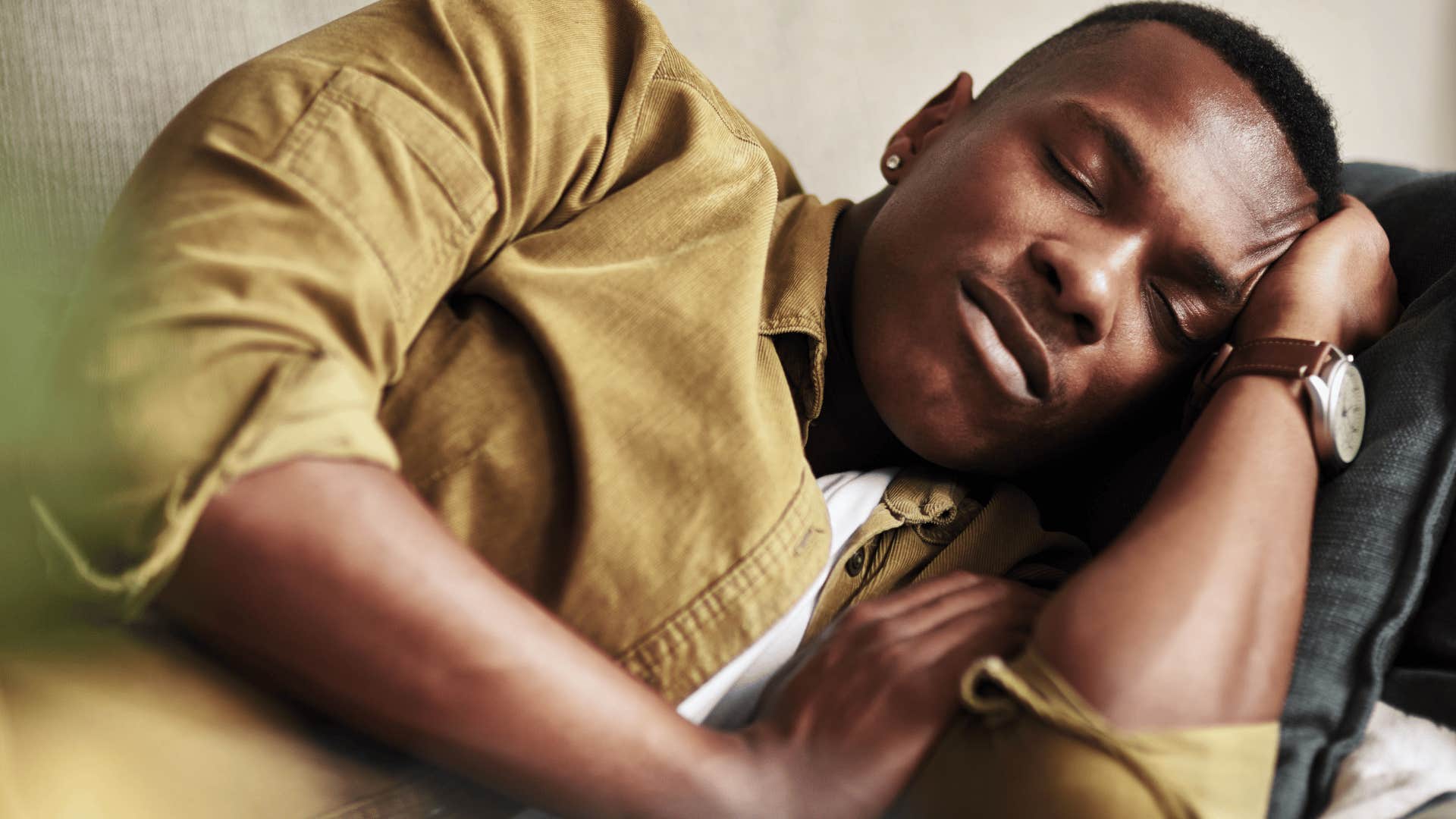 man sleeping by himself and not in bed with spouse