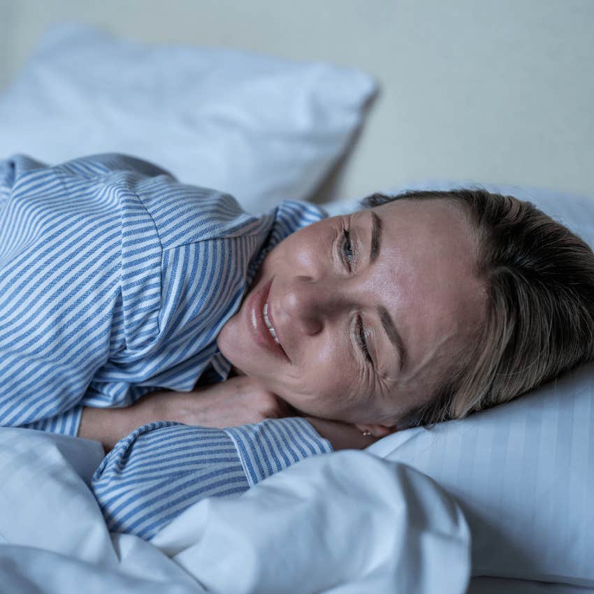happy woman in her 40s going to bed early