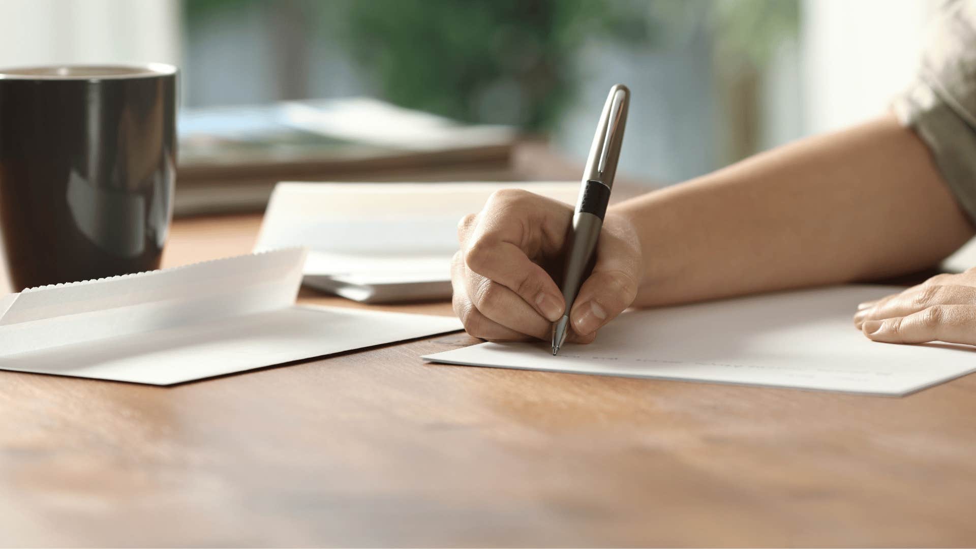 person writing handwritten letters to their friends and family