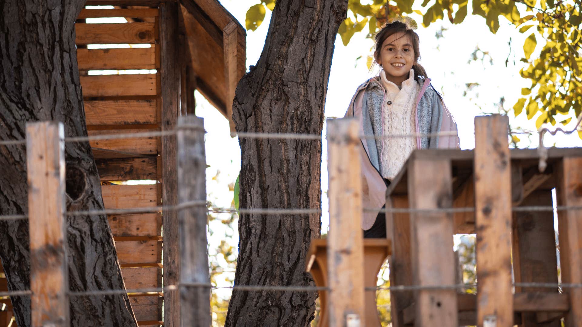 child in a treehouse like people used to have in the 60s and 70s