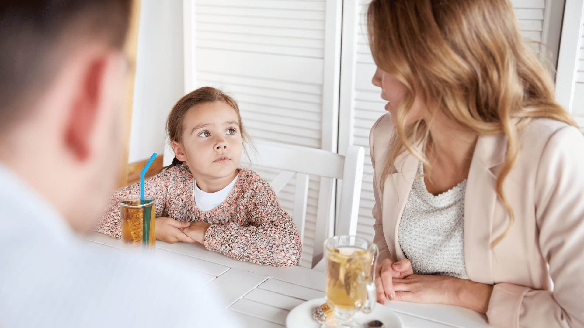 parents having meal together telling daughter don't listen to anyone who disagrees with you