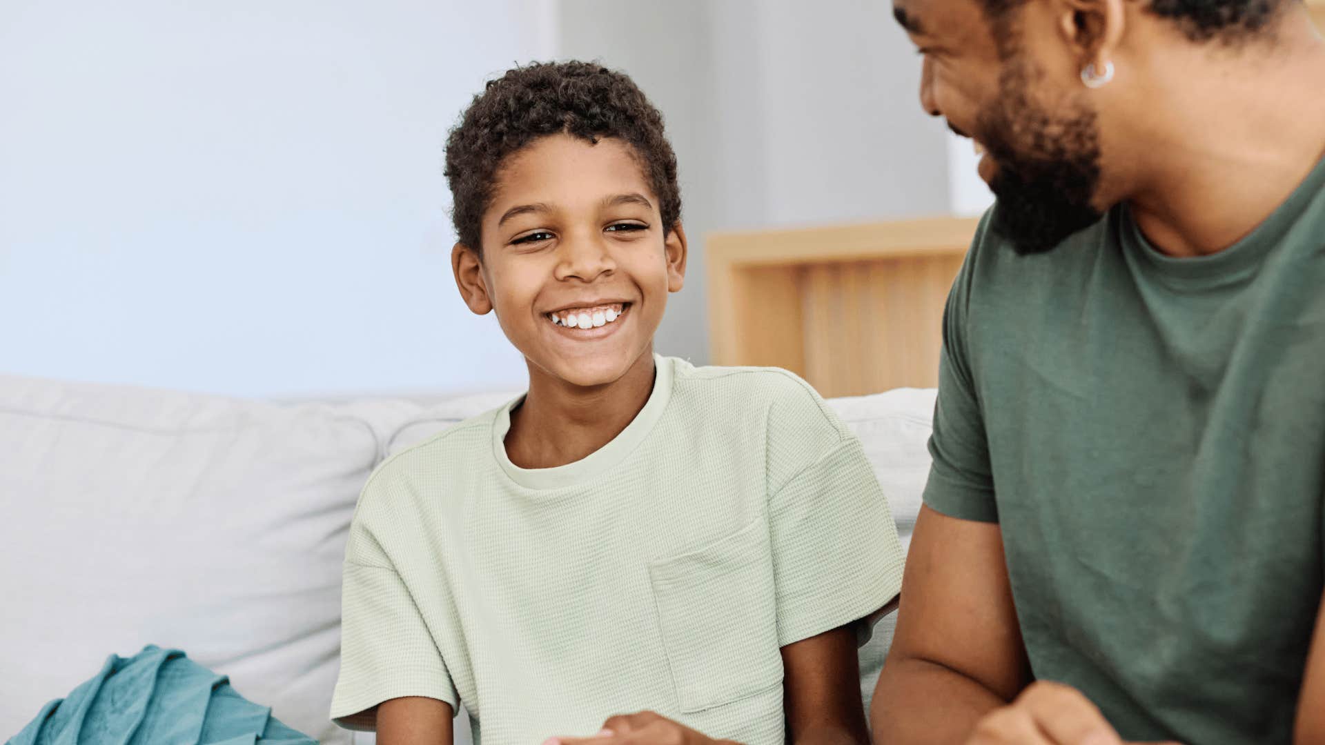 dad talking to smiling son telling him you deserve it because you want it