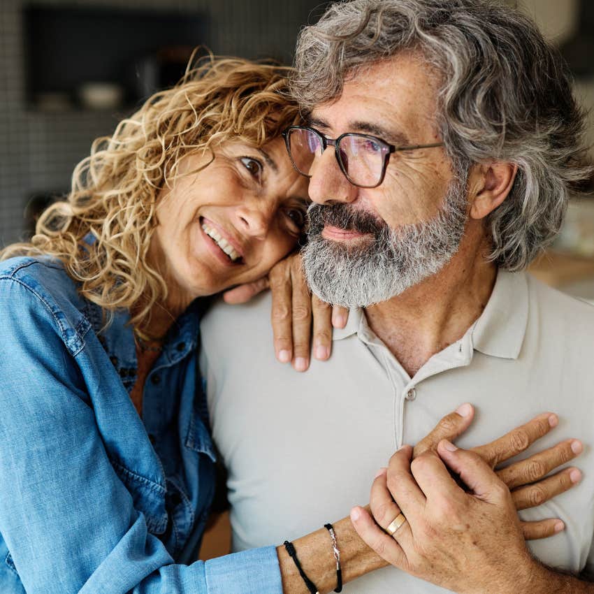 middle aged parents accepting change hugging each other