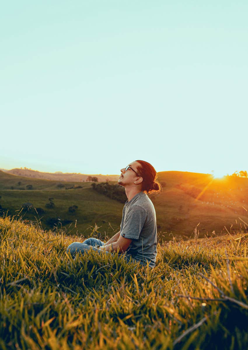 peaceful man meditating outdoors