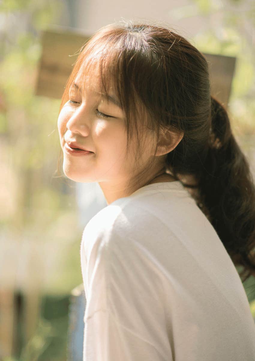 peaceful young woman with her eyes closed not competing
