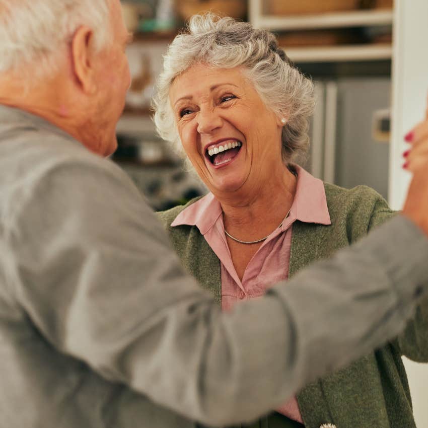 happy older couple accepting the aging process and dancing together