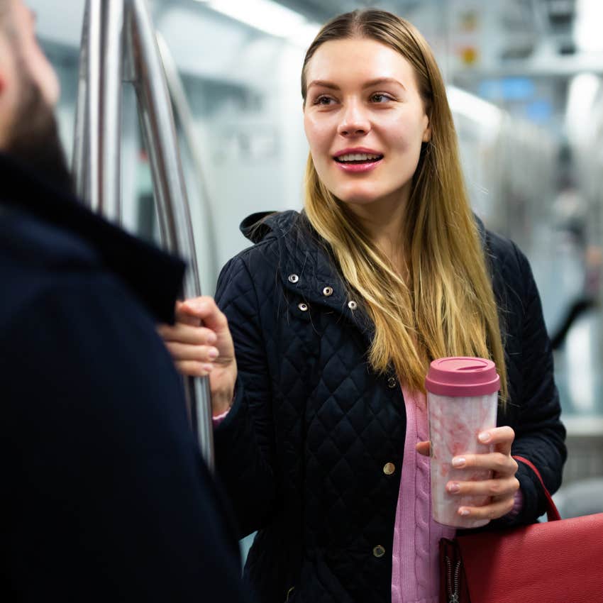 Woman who can talk to anyone having a conversation with a stranger on the train