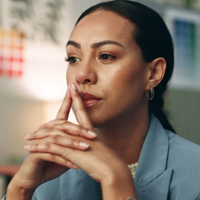 gen X woman feeling skeptical thinking deeply at work