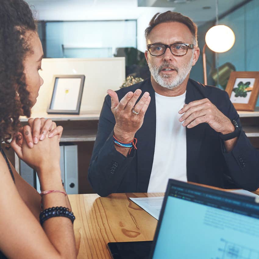man using corporate jargon with young co-workers in an office