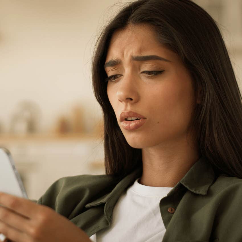 gen z woman dealing with rejection while looking at her phone