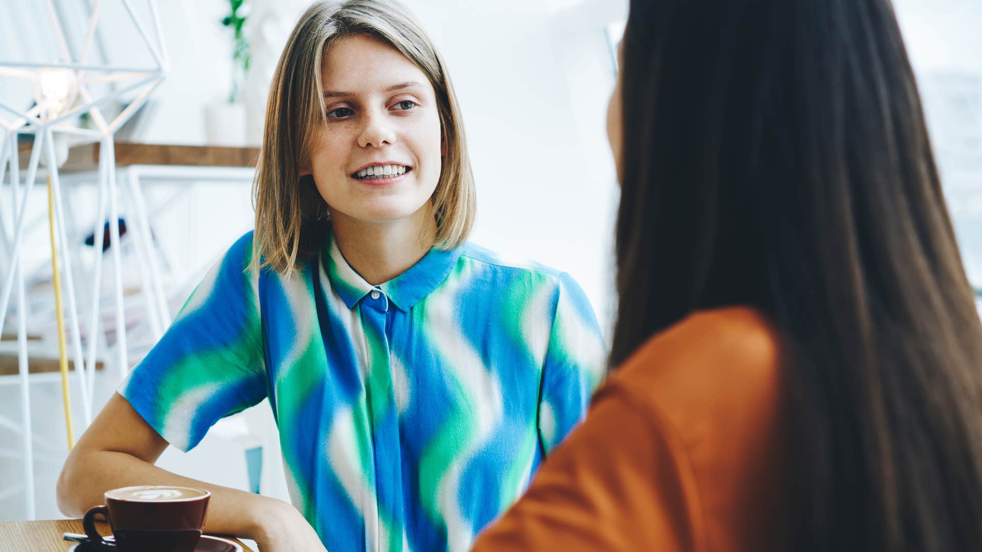 Woman raised in the 80s or 90s dealing with awkward silence in a conversation