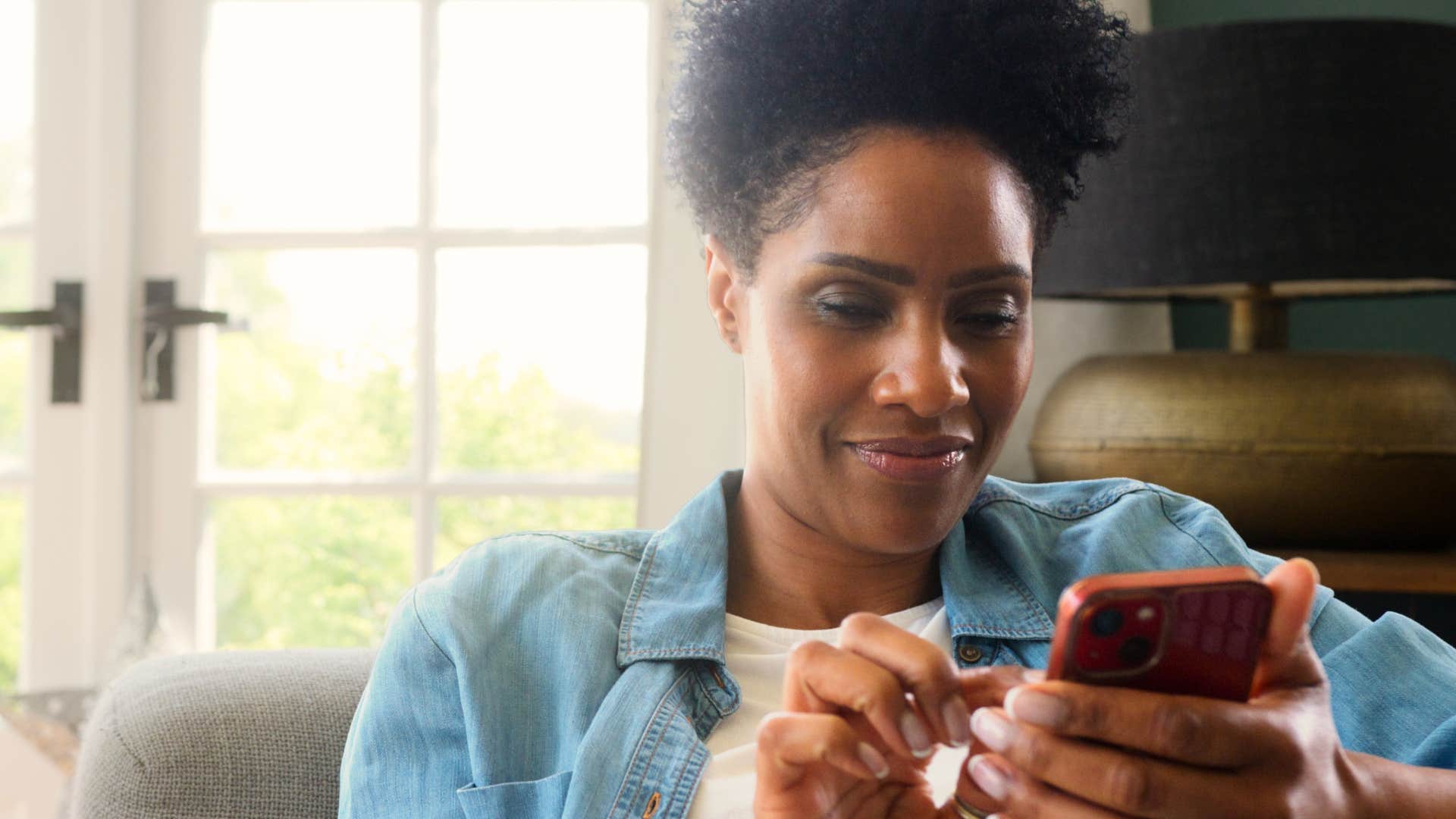 Woman smiling at last-minute cancellations on her phone