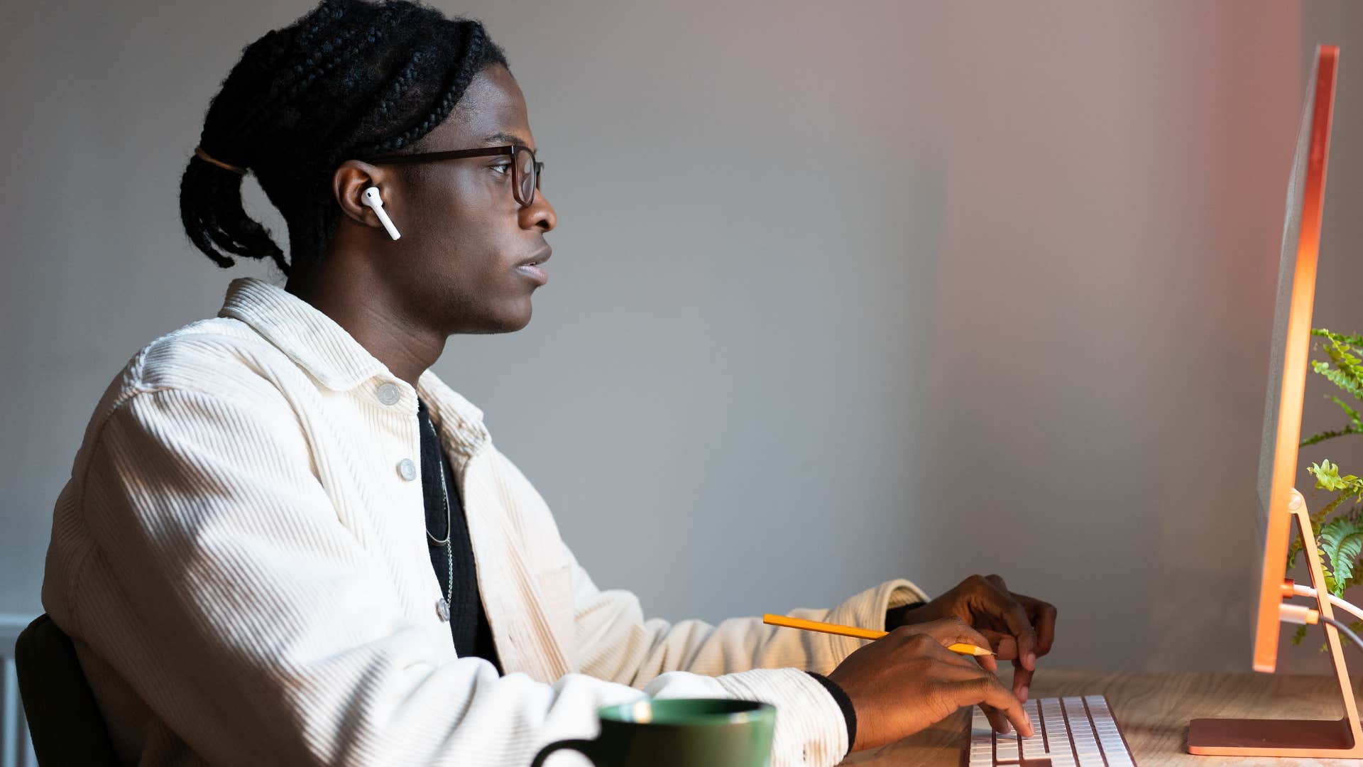 Millennial man needing to multitask at work