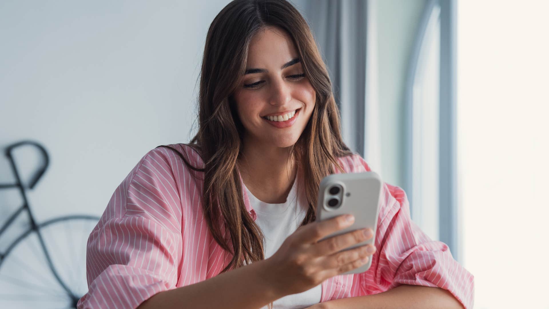woman raised in the 90s looking at negative comments on her phone