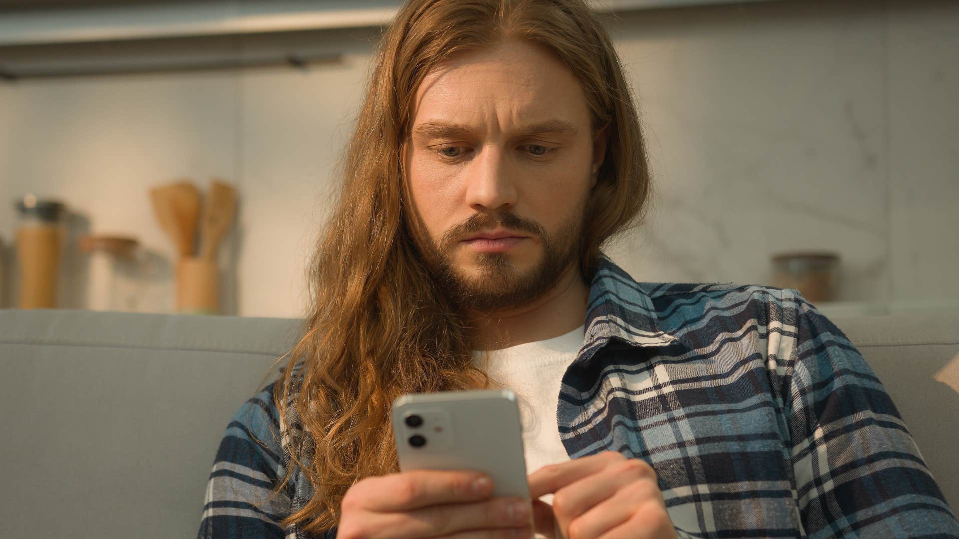 Man curating a presence on social media looking at his phone.