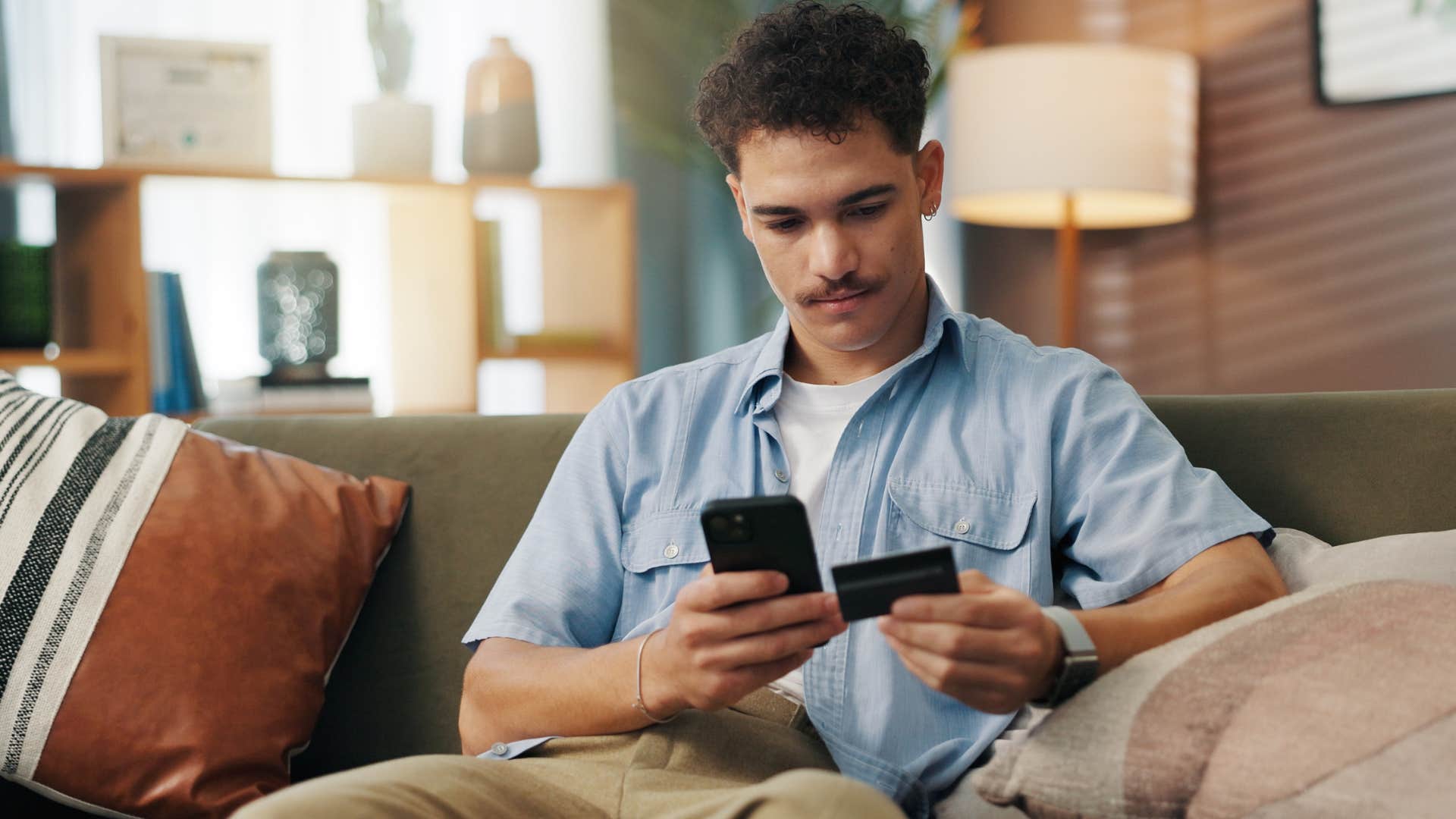 Man online shopping for fast fashion on his phone.