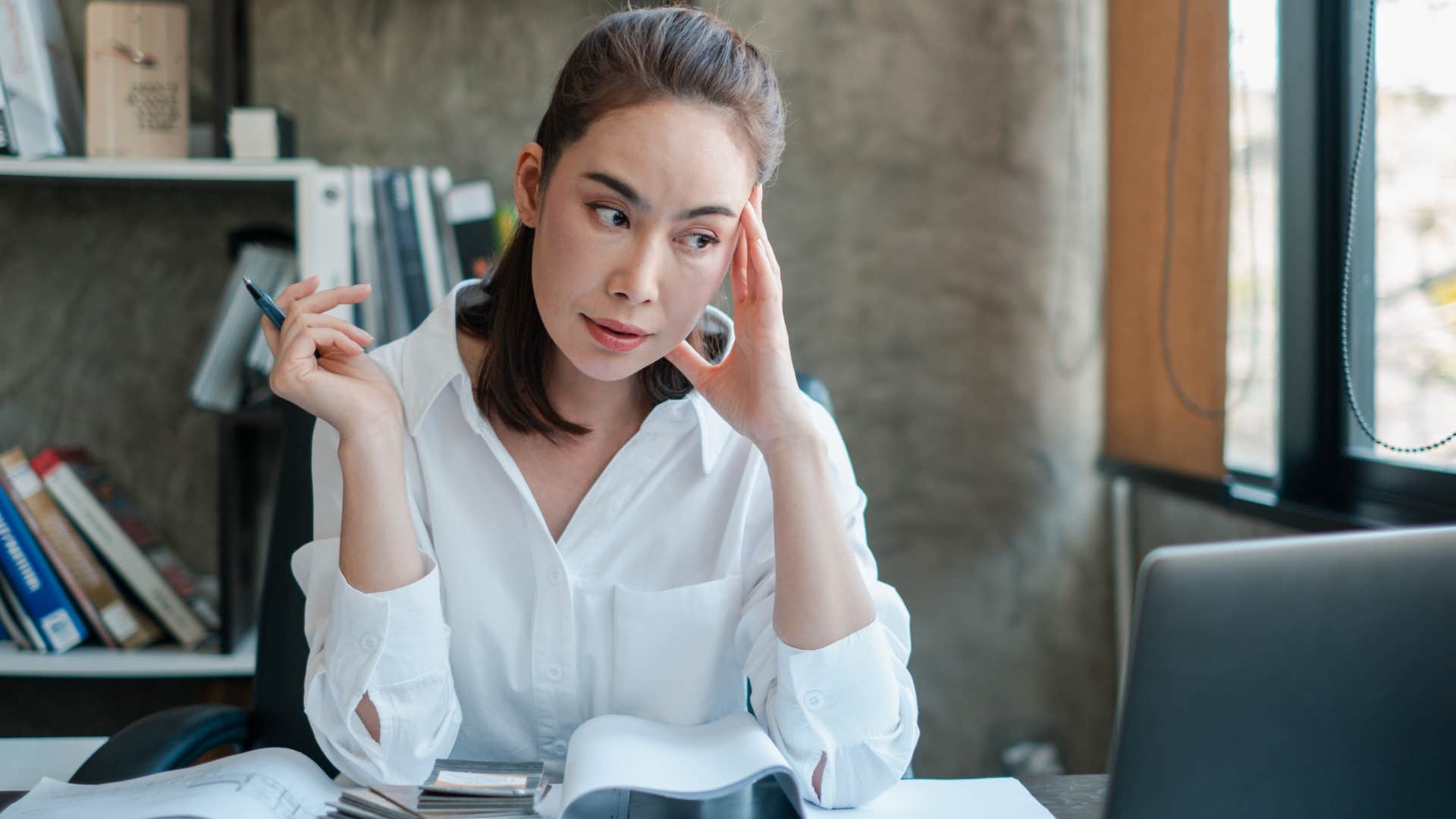 Woman finding meaning at work looking at her laptop.