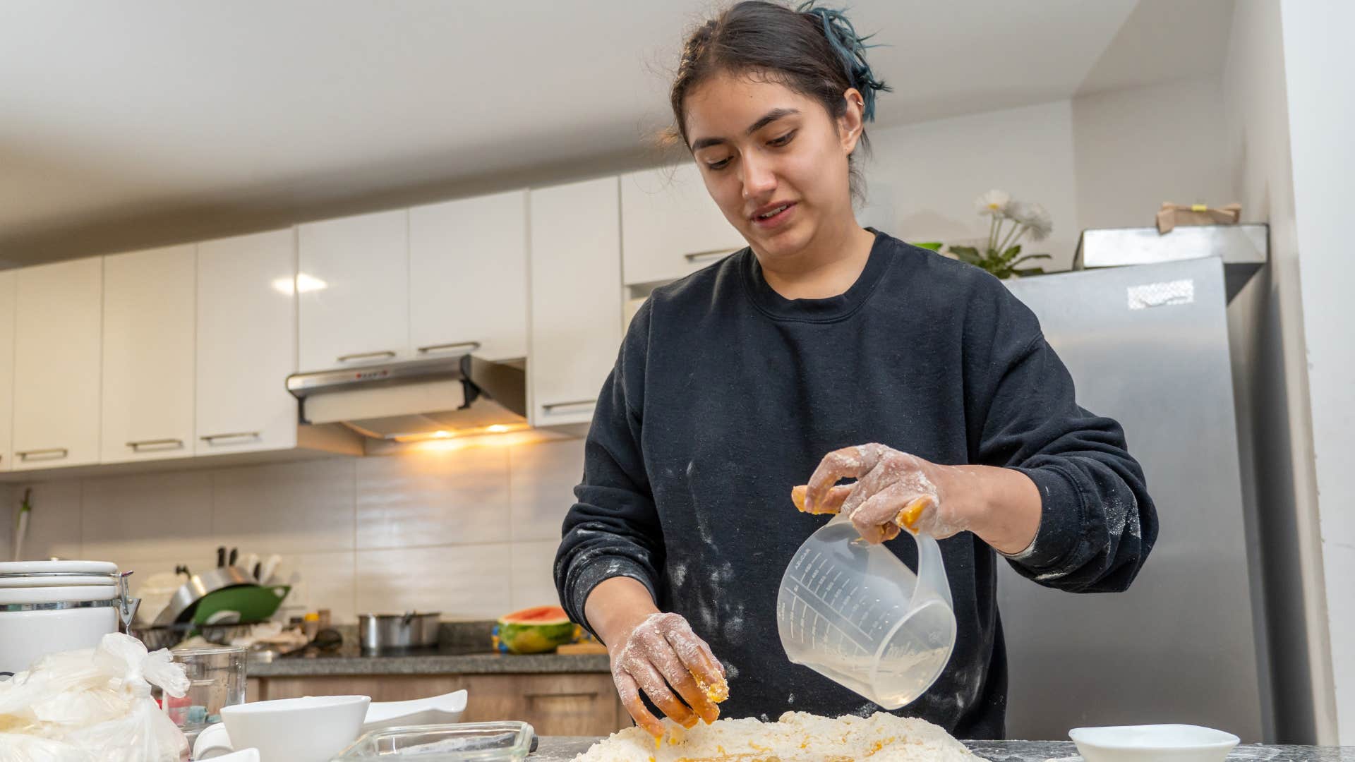 Gen X woman cooking for herself at home