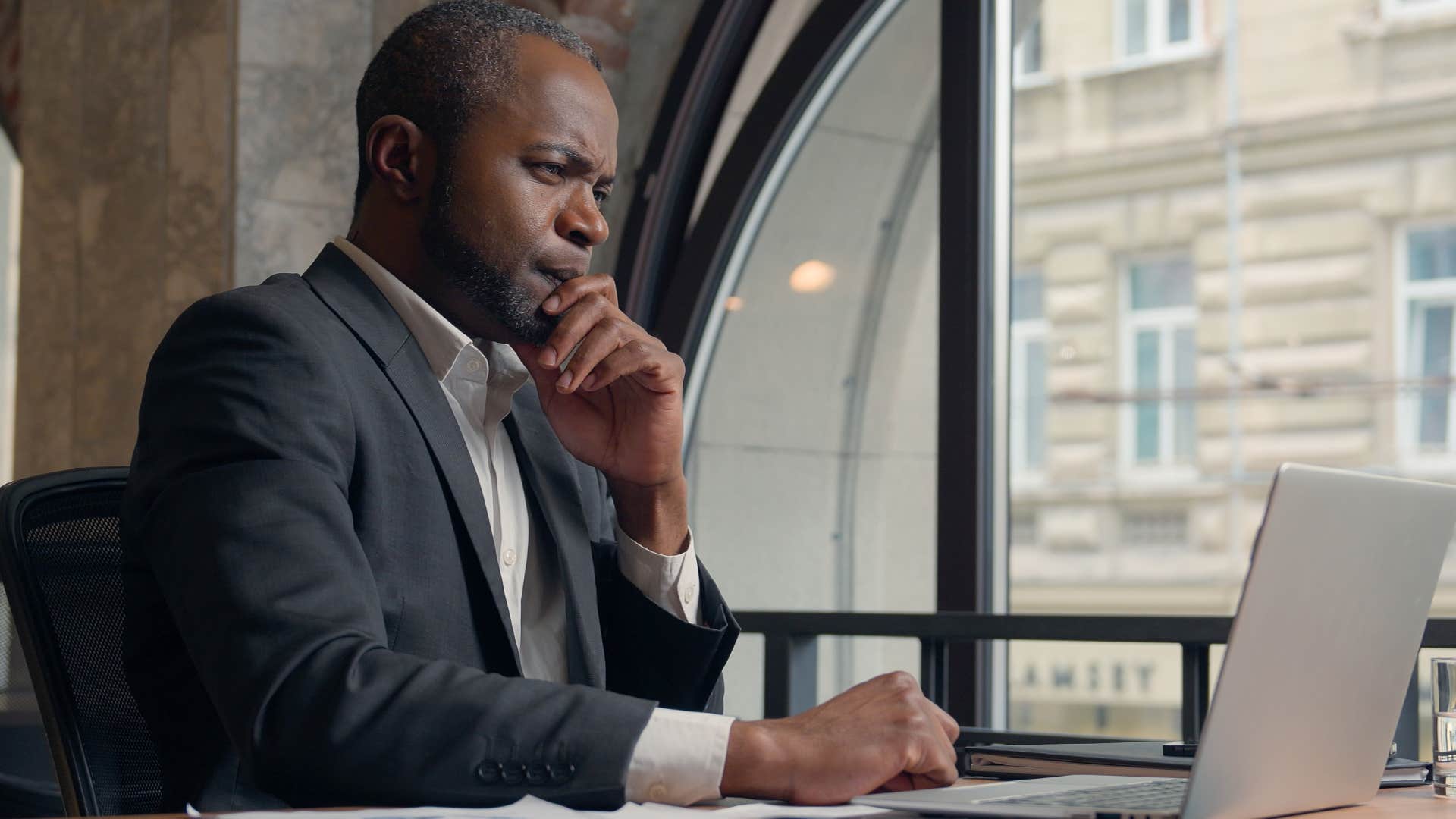 Gen X man using critical thinking skills at work