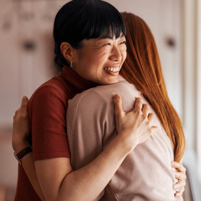 Empathetic woman hugging her friend at home