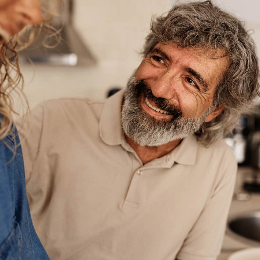 Man who knows how to host smiling with a friend at home