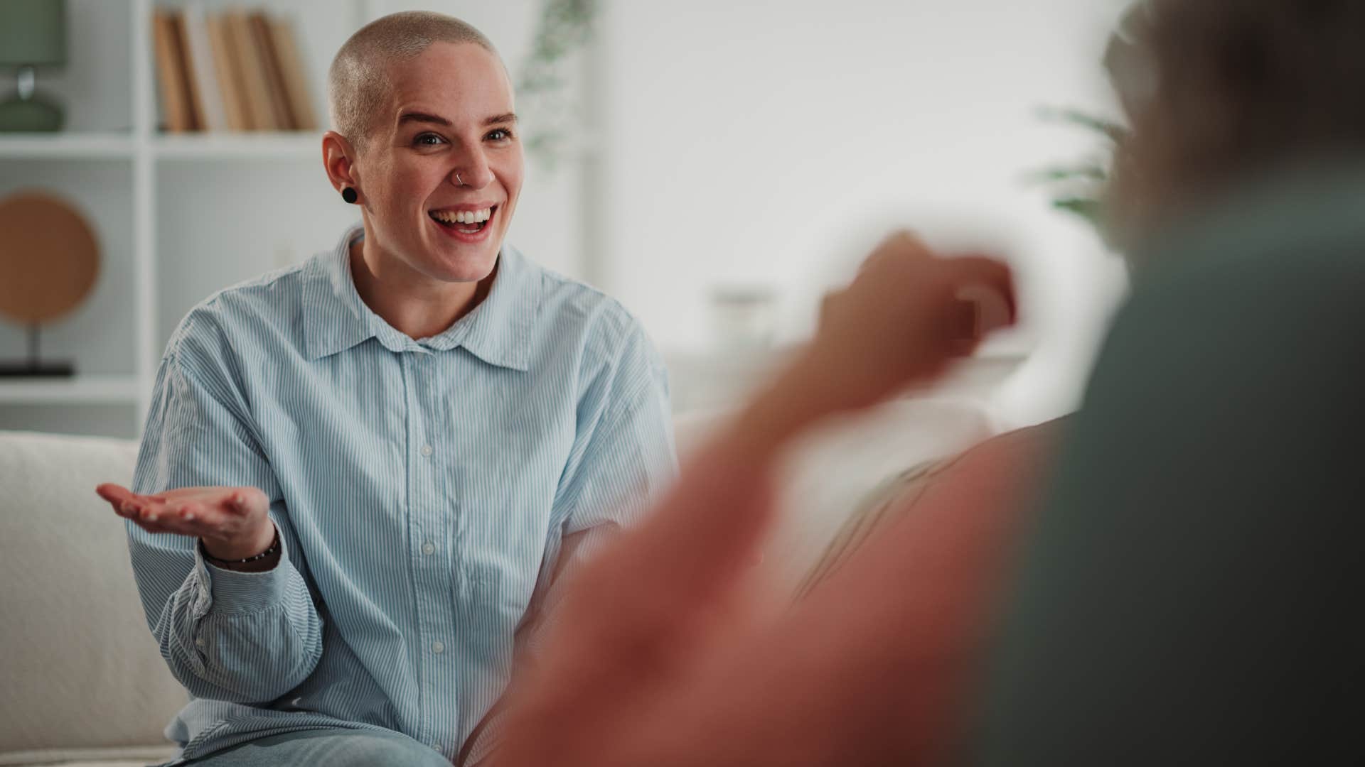 woman laughing with friend sitting across from her
