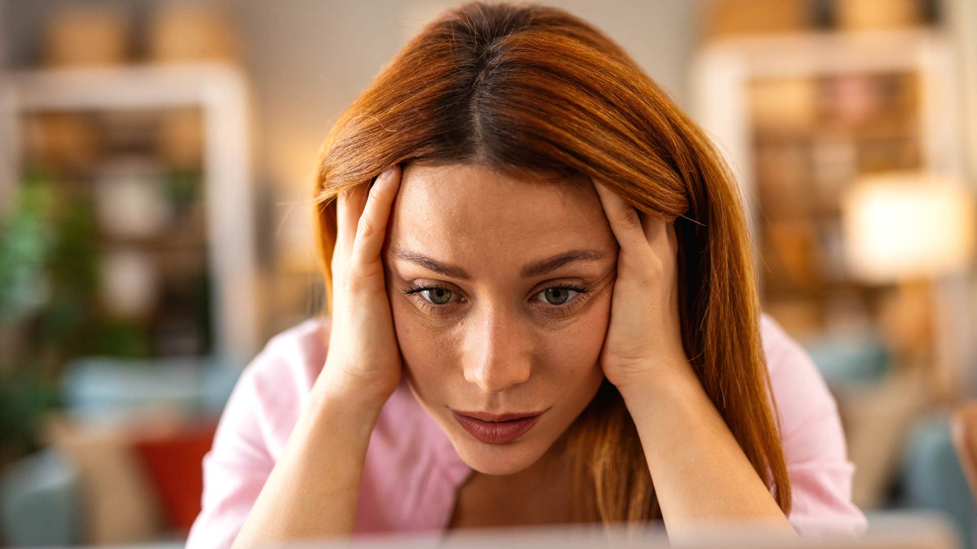 burnt out woman staring at her computer wanting to cancel plans
