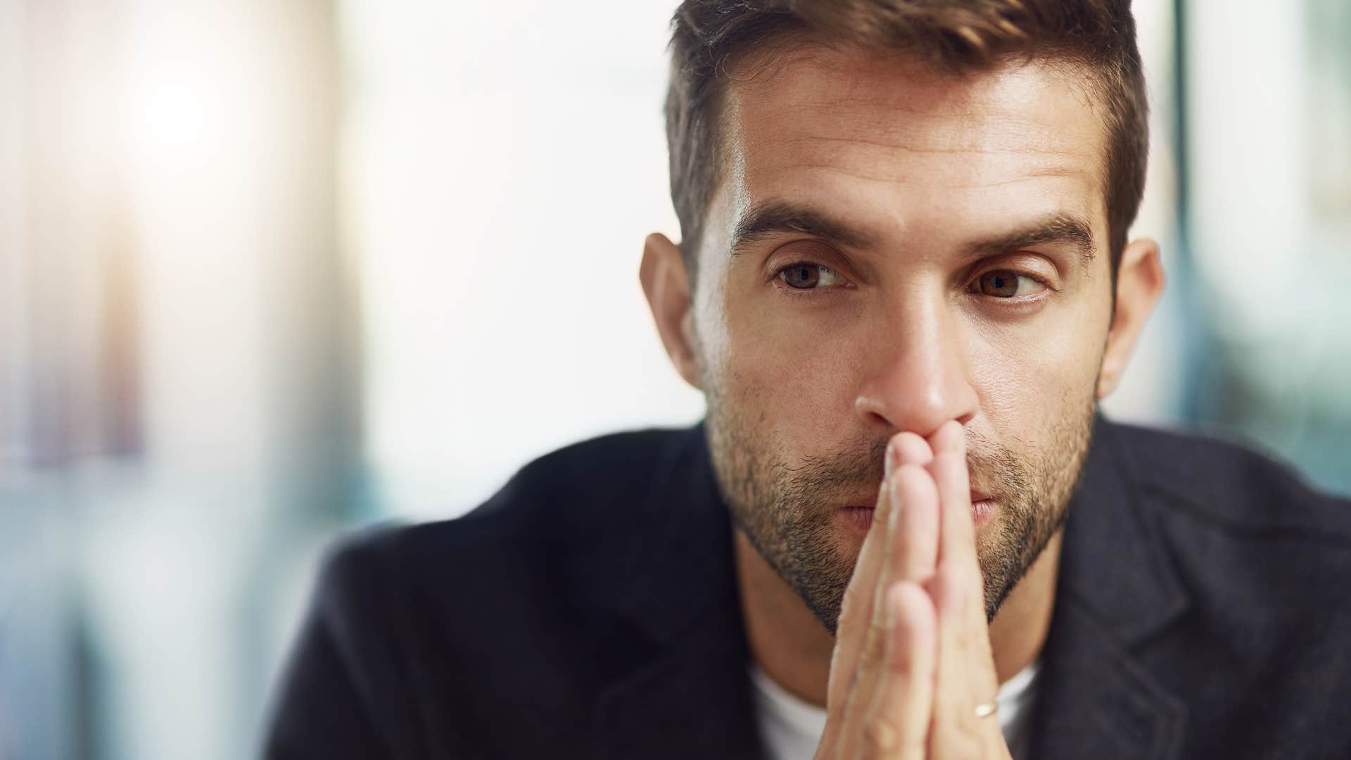confused man ignoring text messages because he doesnt know what to say
