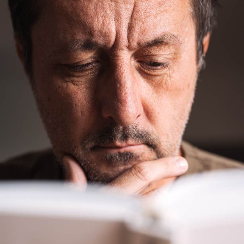 intelligent dyslexic man trying to read a book at home