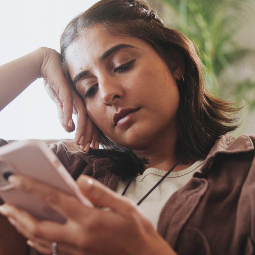 high-iq woman who's easily distracted looking at her phone