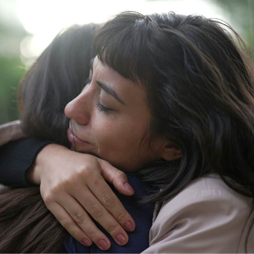 high-iq woman who is emotional hugging her friend