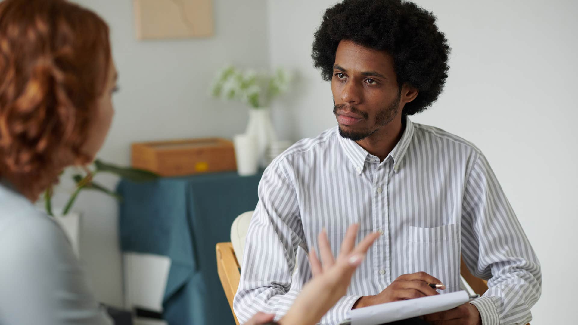 man using few hand gestures while talking to a co-worker