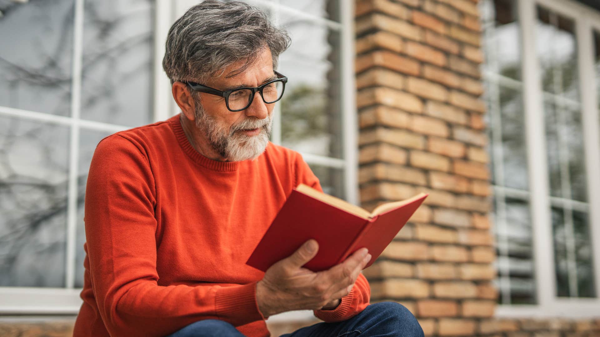 man with good morals reading a book trying to learn new things