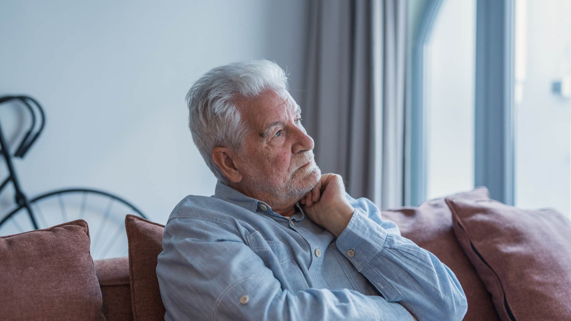 pensive boomer who misses his old routine thinking deeply at home