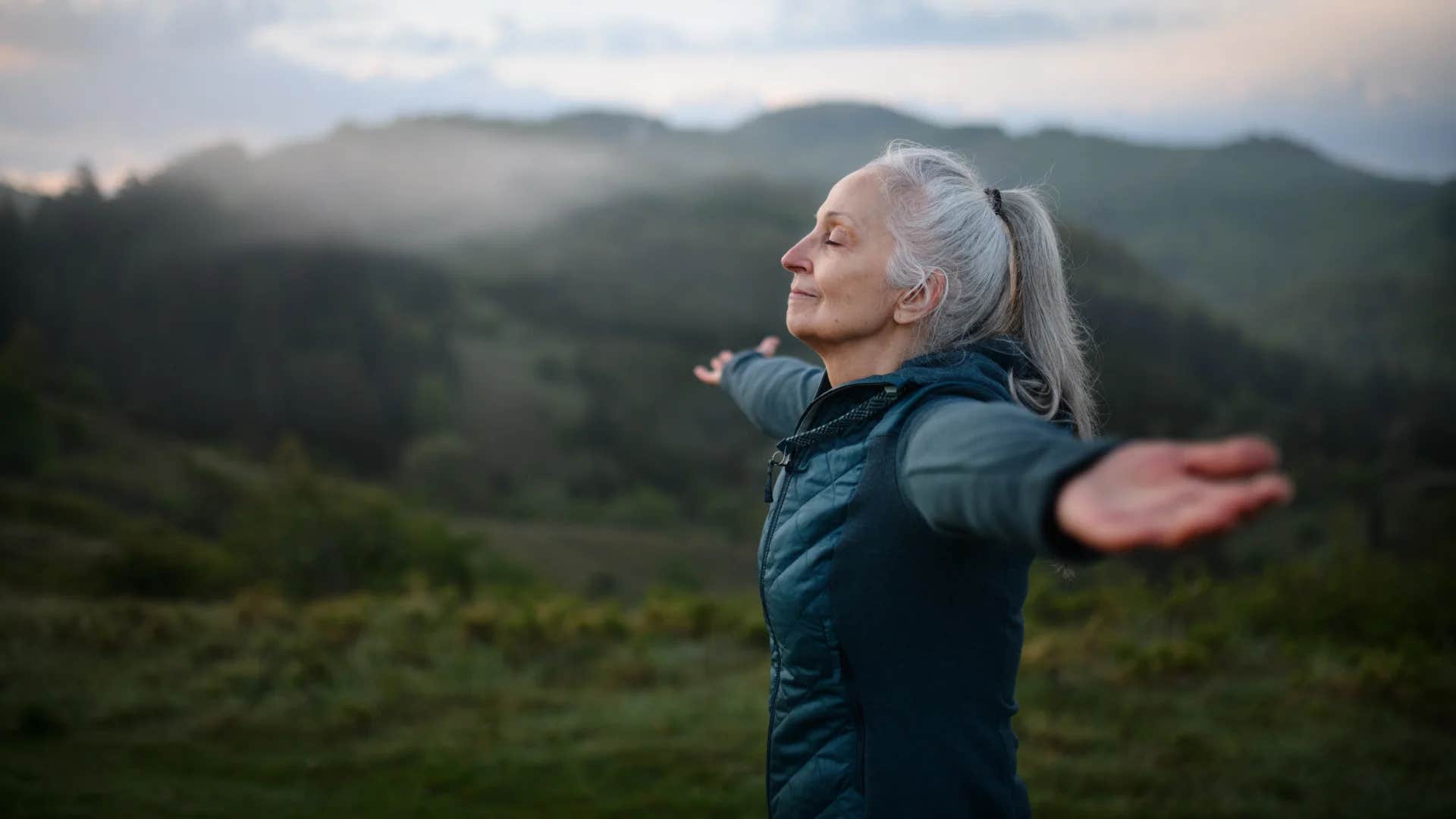 woman feeling free on a hike finding silver linings in her struggles