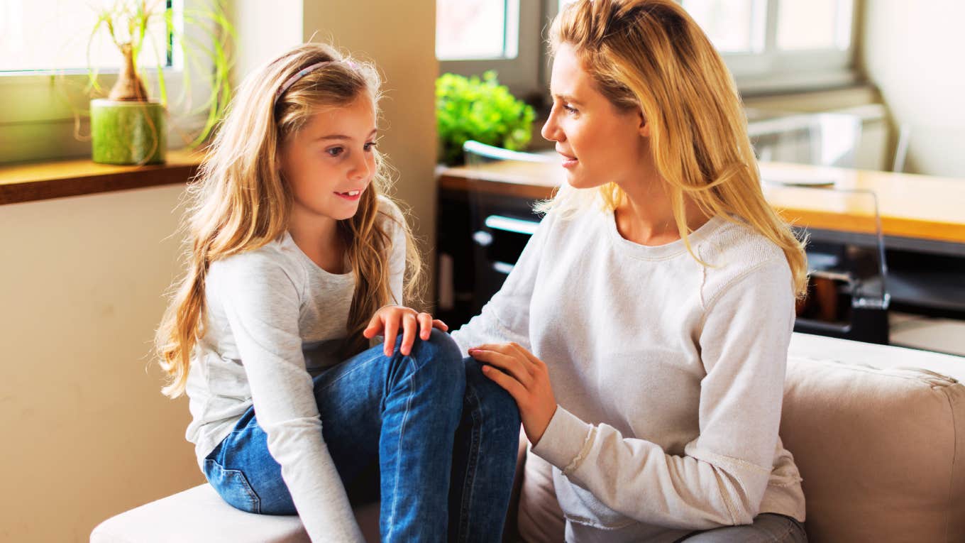 A portrait of a young child engaged in a serious conversation with their mom; illustrating the psychological concept of 'emotional incest' or role reversal where a parent uses a child as a primary emotional confidant.